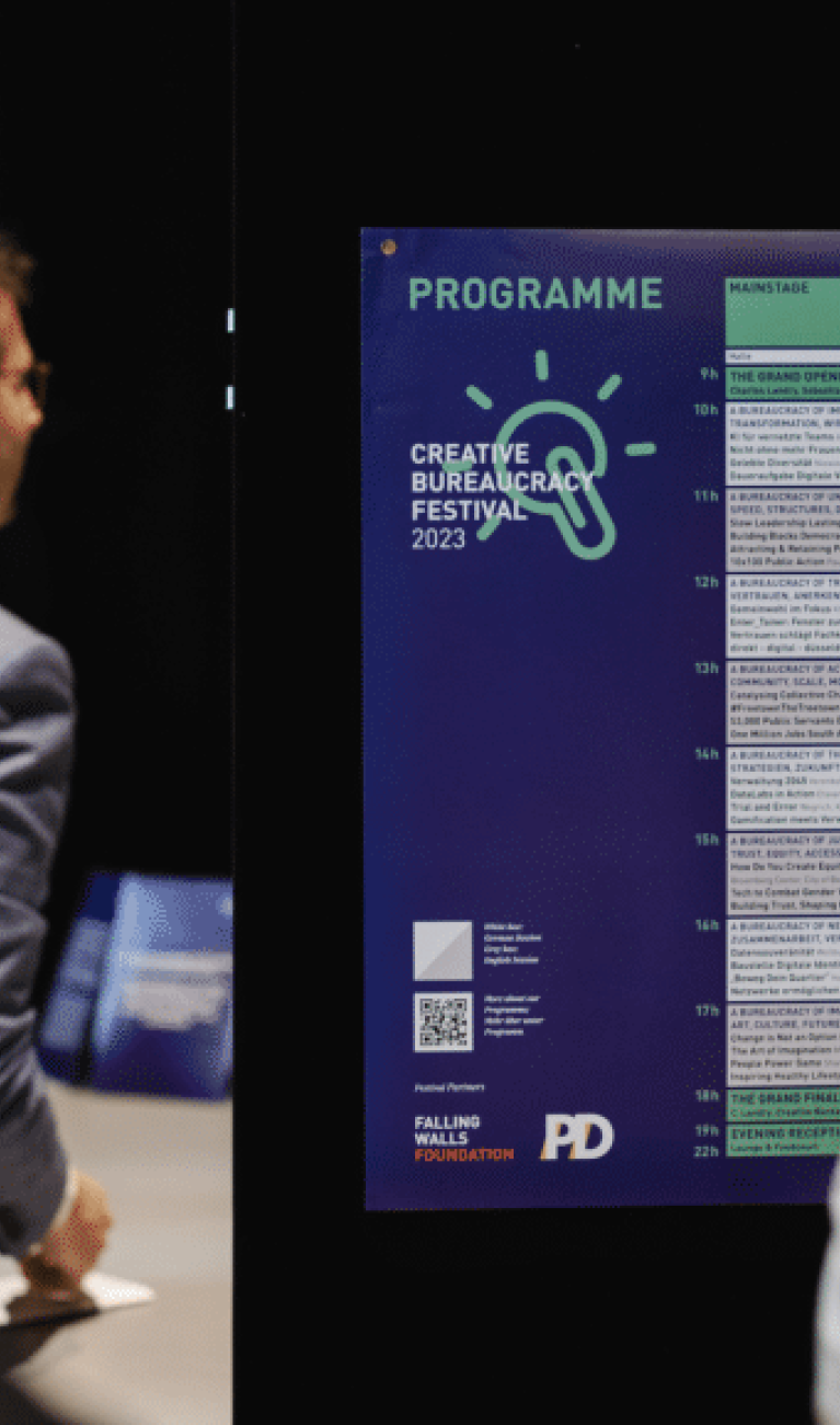people standing infront of a poster with the programme